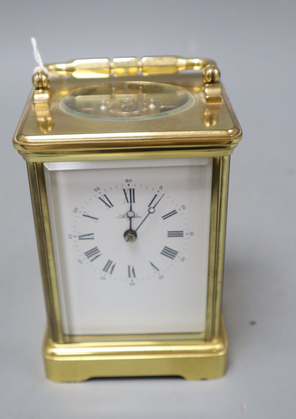 A modern gilt brass enamel dial upright rectangular striking carriage clock, signed Angelus to white Roman dial, overall height 14.5cm